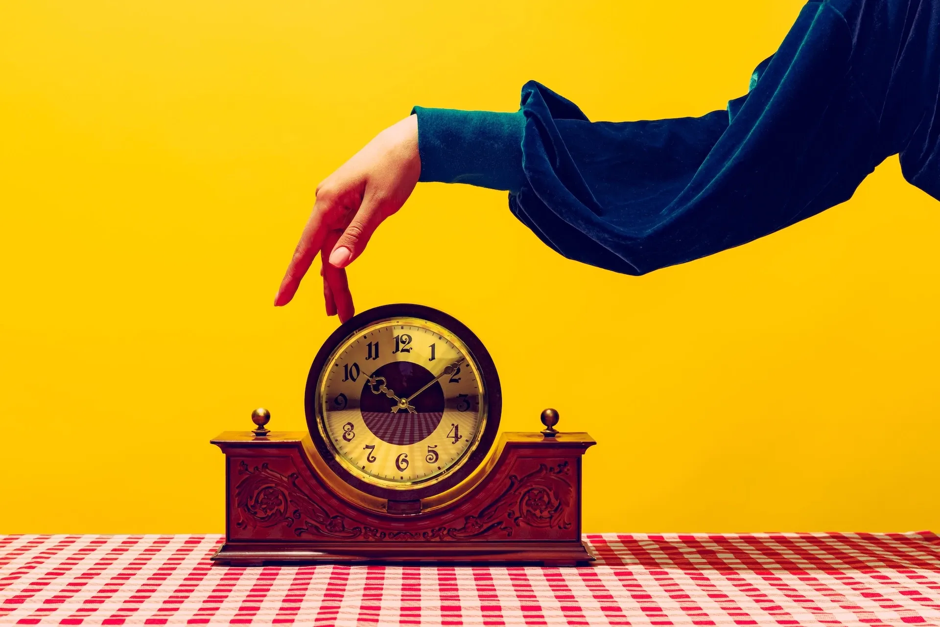 Woman’s hand on a clock 