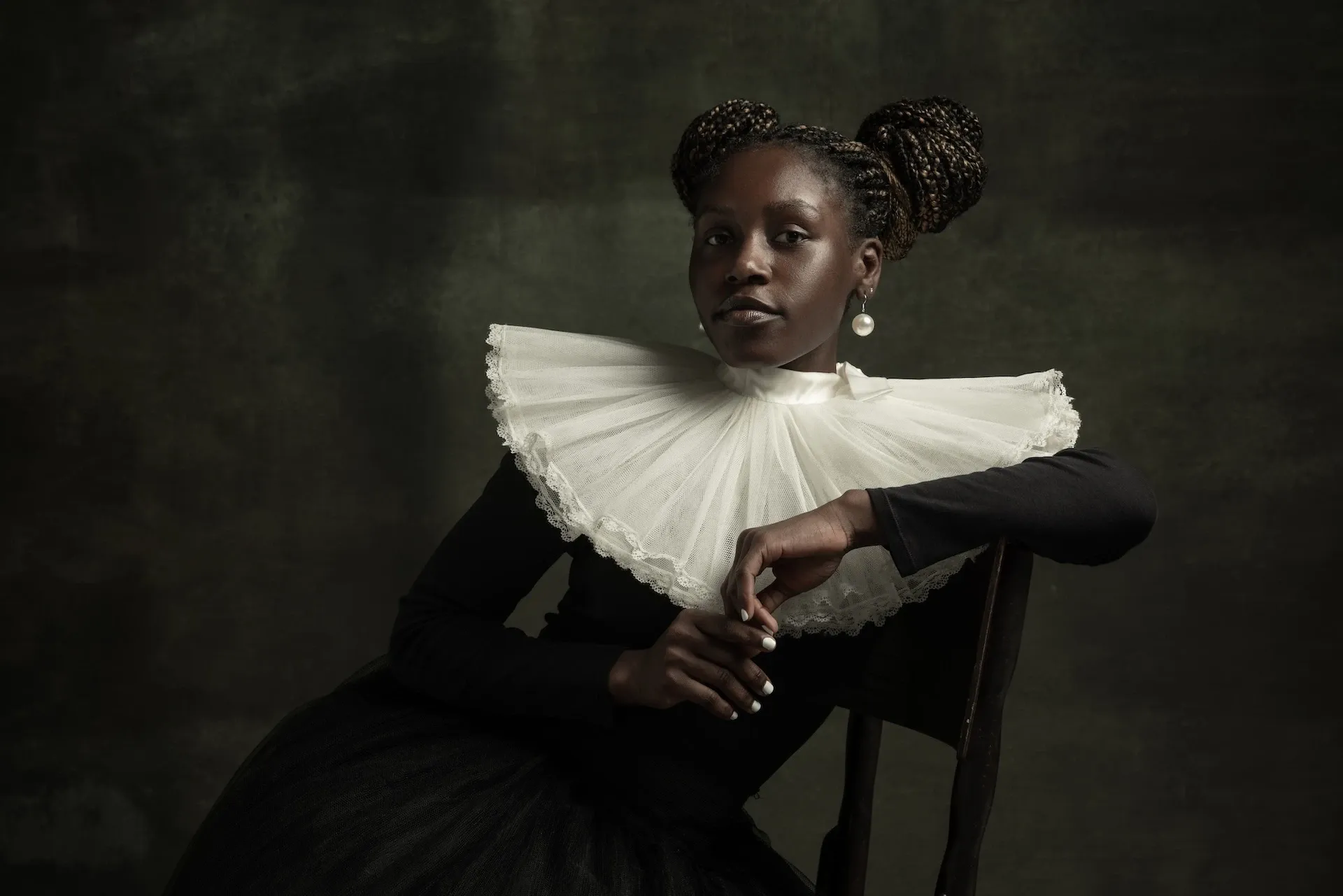 Woman in Victorian clothes sitting on a chair