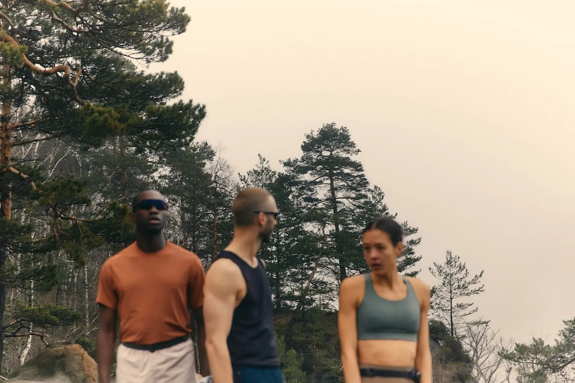 A group of people working out in the woods
