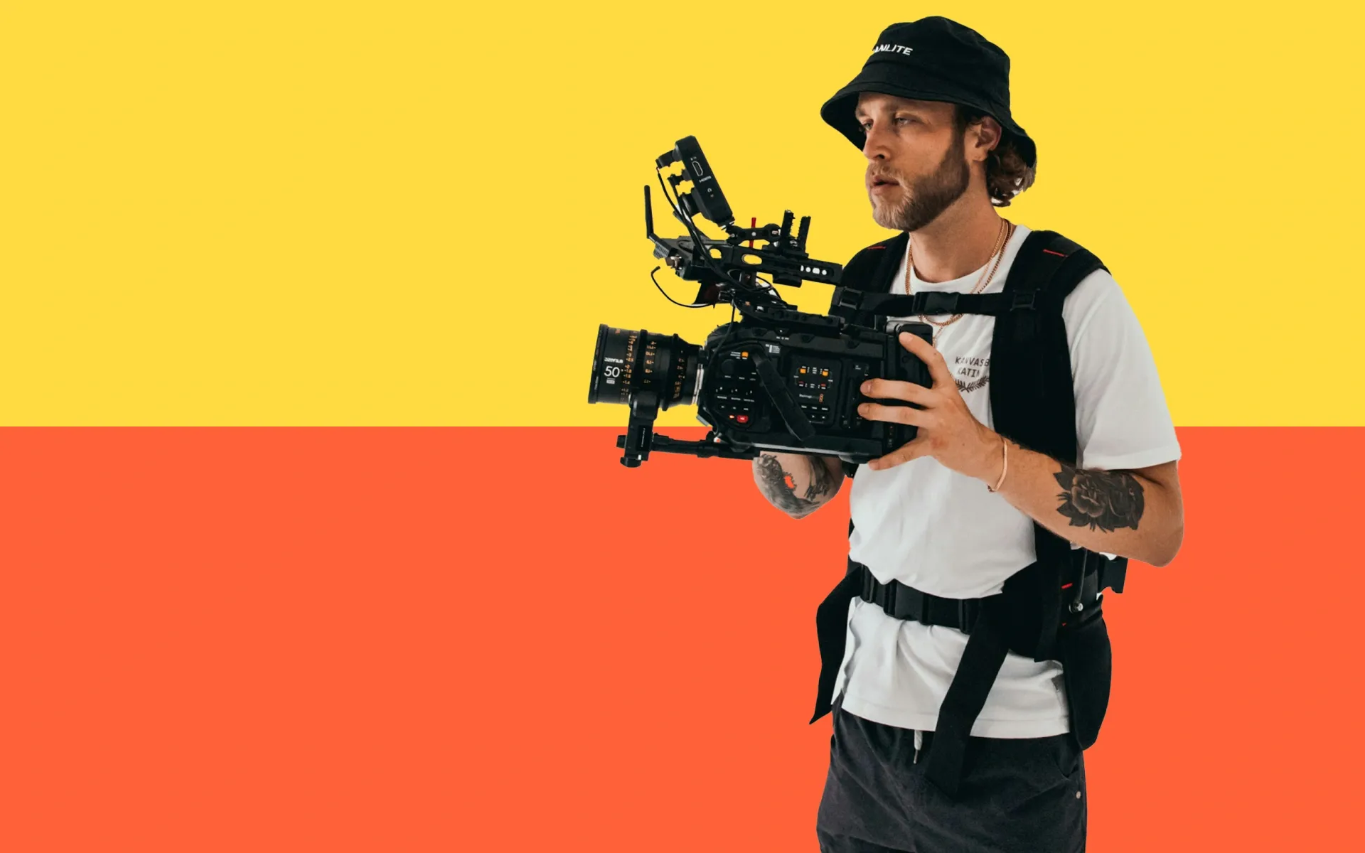 A man in a bucket hat, holding a camera