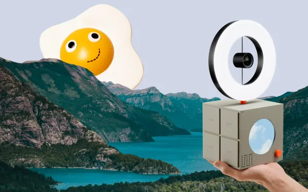 A fried egg hiding behind a mountain. A square device with a ring light tries to capture the scene.